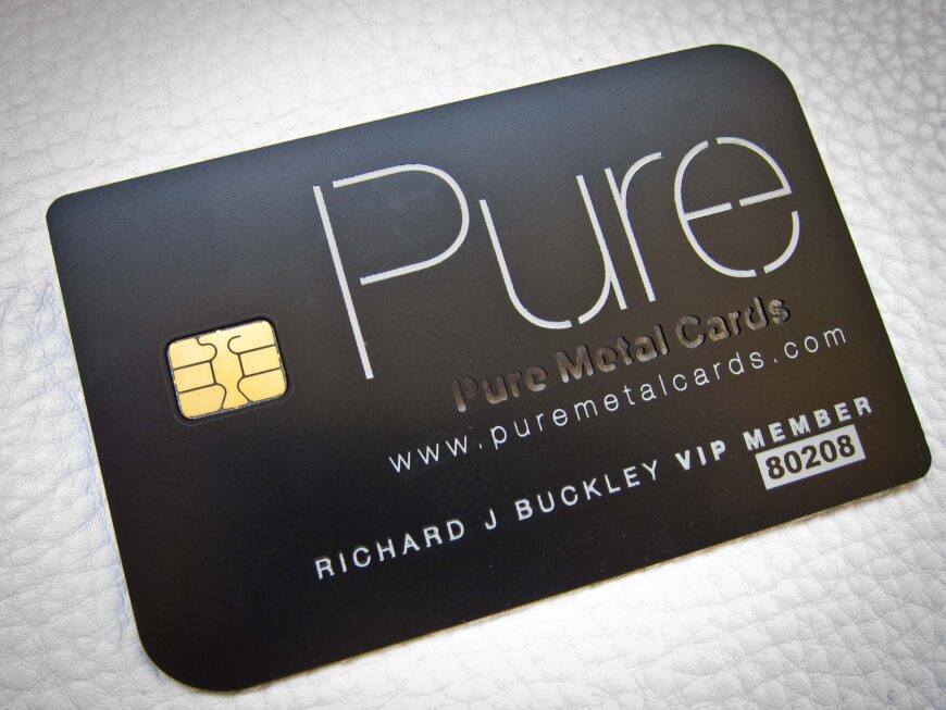 Matte black metal business card with "PURE" logo and member details.