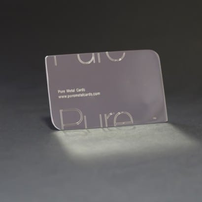 Silver business card with "Pure" logo, showcasing elegant design. Pure Metal Cards.