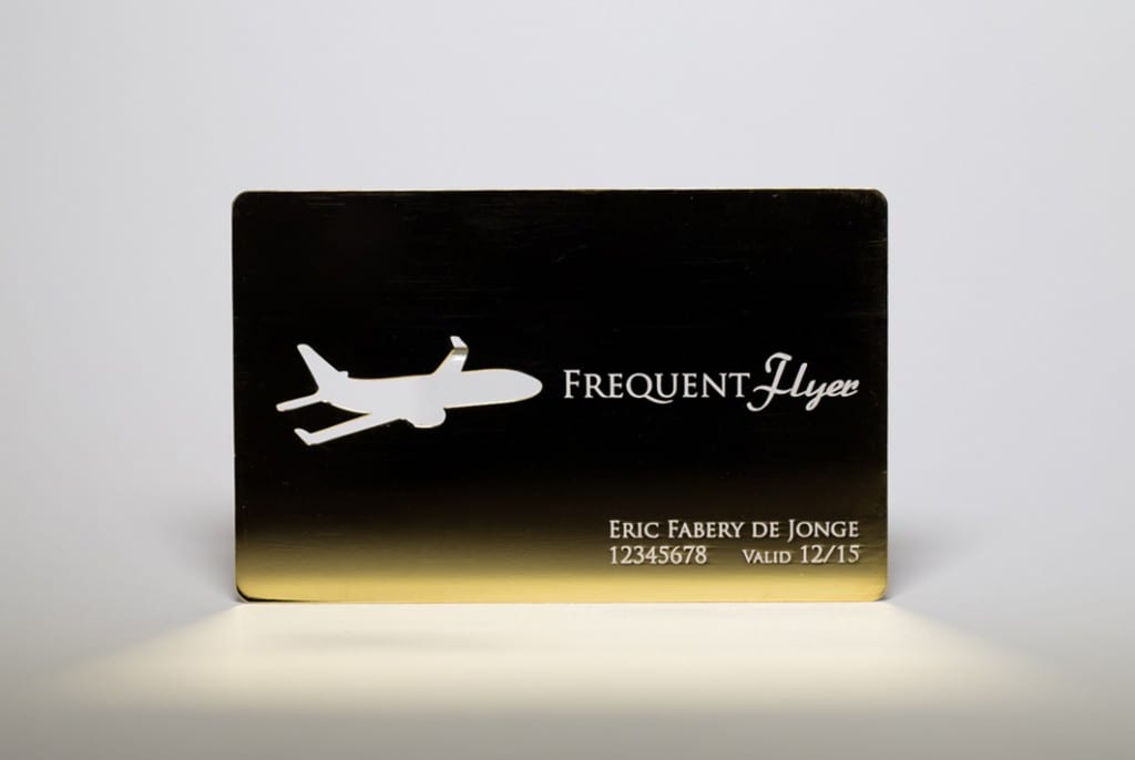 Gold-plated frequent flyer card with airplane cutout. Eric Fabery de Jonge, 12345678, Valid 12/15