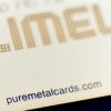 Close-up of a brass mirror card; puremetalcards.com
