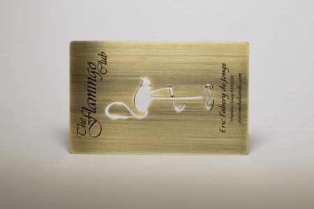Antique brass business card featuring The Flamingo Club logo.