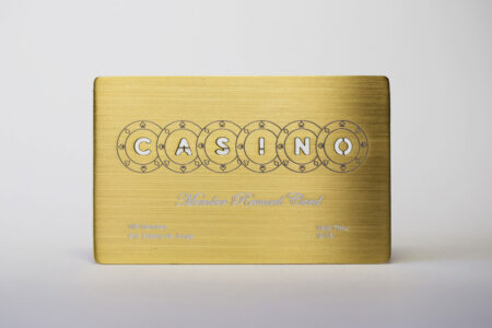pure-metal-cards-brass-gold-brushed-card-1 Gold brushed metal casino reward card. "CASINO" is cut out of the card.