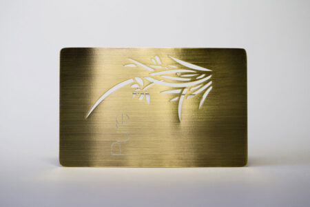 pure-metal-cards-brass-gold-brushed-card-2 Gold brushed metal card with "Pure" and cut-out design.