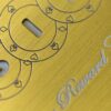 pure-metal-cards-brass-gold-brushed-card-close-up-1 Close-up of brushed gold card with "Reward Card" inscription and poker suit details.