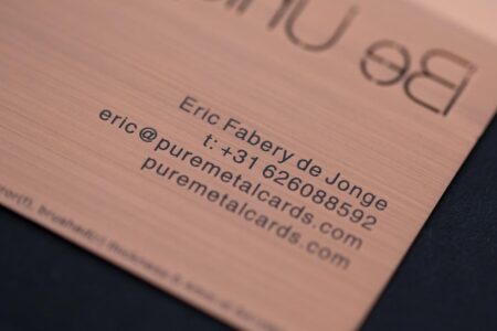 pure-metal-cards-copper-brushed-card-close-up-1 Close-up of a copper brushed metal business card with contact details.