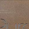 Close-up of copper frosted metal business card with "Pure Metal Cards" and website address.
