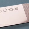 pure-metal-cards-copper-mirror-1 Rose gold metal business card with "Be Unique" and subtle mirror effect.