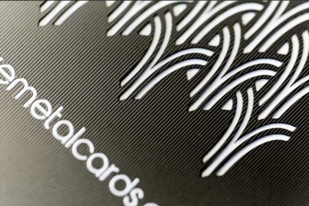 Close-up of a matt black contour stainless steel card with etched design. Metalcards.