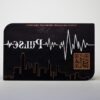 pure-metal-cards-matt-black-copper-card-2 Matt black copper business card with "Pulse" logo and city skyline.