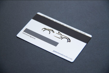 Silver plated metal business card with a car graphic and "Authorized Signatory" text.