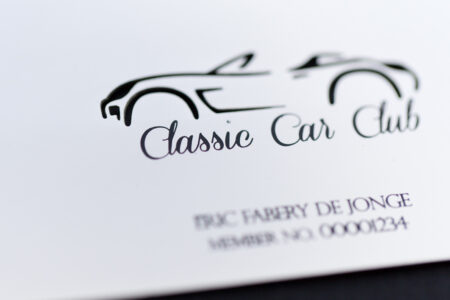 Close-up of a silver-plated Classic Car Club membership card.