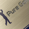 Brushed stainless steel plate with "Pure Golf" logo and golfer silhouette.