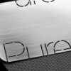 Close-up of brushed stainless steel business card; Pure Metal Cards website address.