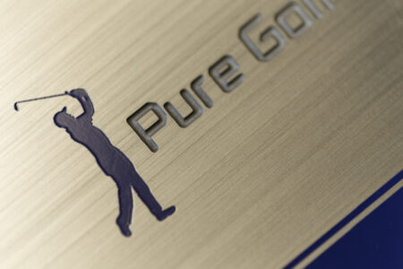 Brushed stainless steel plate with "Pure Golf" logo and golfer silhouette.