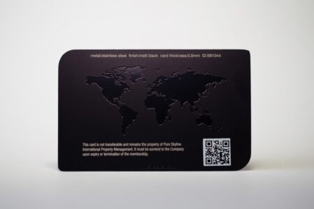 Matt black stainless steel card with embossed world map and QR code.