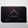 Matt black stainless steel business card with embossed logo and contact info.