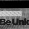 silver-prism Close-up of a silver prism stainless steel card, showcasing the words "Be Unique".