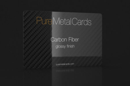 Glossy black carbon fiber business card with "Pure Metal Cards" logo.