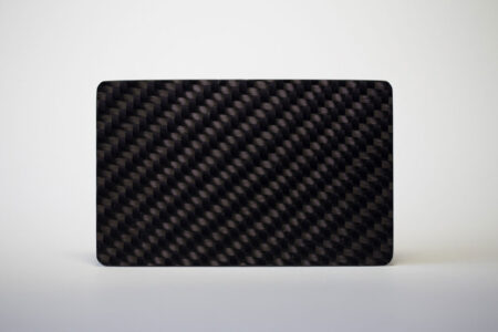 Black carbon fiber business card with a glossy finish.