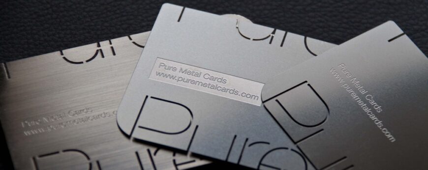 Metal business cards with "Pure Metal Cards" and website address.