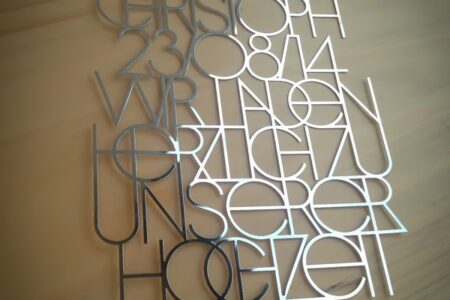 Silver metal VIP passes with names and dates.