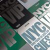 2 NYC VIP passes and guest passes; metallic, engraved designs.