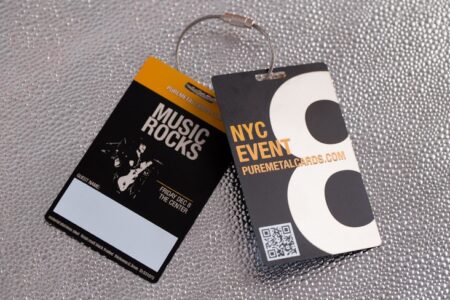 Two VIP passes with metallic finishes; one for a music event, one for a NYC event.