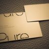 pure-metal-cards-mini-metal-card-1 Gold metal mini cards with logo and website address.
