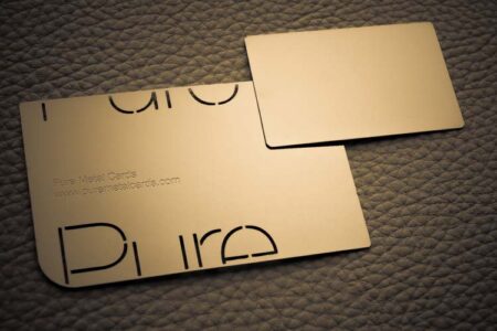 Gold metal mini cards with logo and website address.