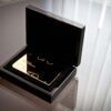 Luxury black wood presentation case with gold Puro card inside.