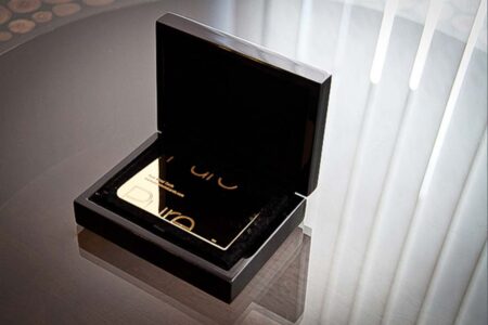 Luxury black wood presentation case with gold Puro card inside.