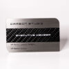 Brushed stainless steel business card with carbon fiber inlay. "Executive Member" and VIP details are visible.