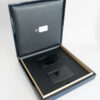 Luxury gift box containing two sleek black titanium cards. "AI Society" is printed on the cards.