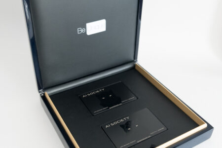 Luxury gift box containing two sleek black titanium cards. "AI Society" is printed on the cards.