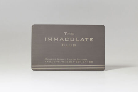 Brushed titanium membership card for The Immaculate Club, member Amber Sloane #001 of 100.