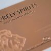 Close-up of elegant copper Contour Card with "Purely Spirits Independently Spirited" embossed.