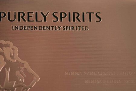 Close-up of rose gold Copper Contour Card; "Purely Spirits, Independently Spirited" embossed.