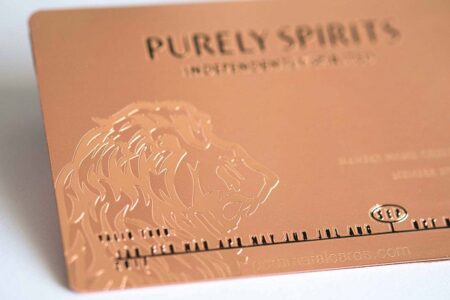 Rose gold Copper Contour Card with embossed lion design. "PURELY SPIRITS" is visible.