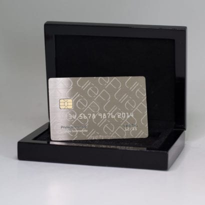 Luxury metal business card in sleek black packaging.