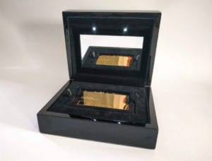Luxury black box packaging with a gold metal business card inside. Packaging designed to showcase premium cards.