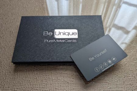 Black fold cardholder with "Be Unique" and social media icons.