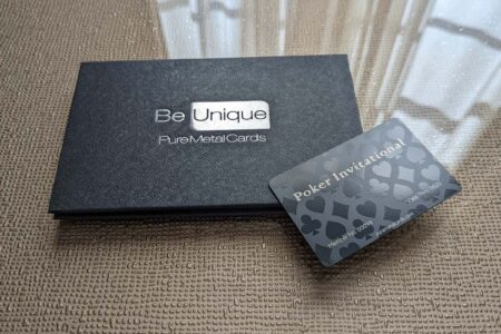 Black fold cardholder with "Be Unique PureMetalCards" and a poker invitation card.