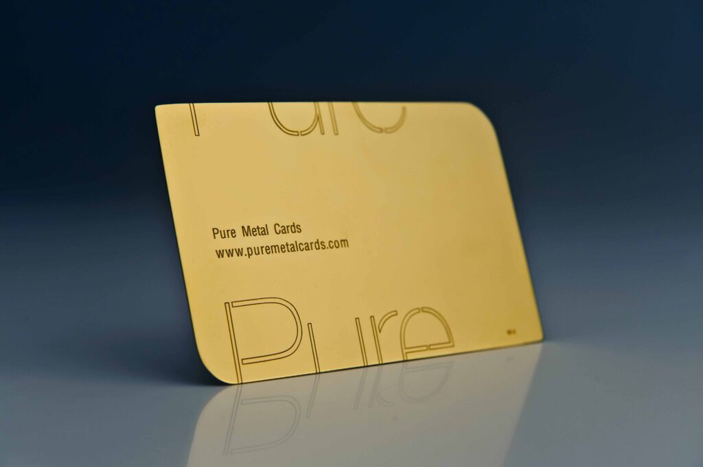 Close-up of a Pure Metal Cards 24 karat gold card with rounded edges. Text: Pure Metal Cards, www.puremetalcards.com