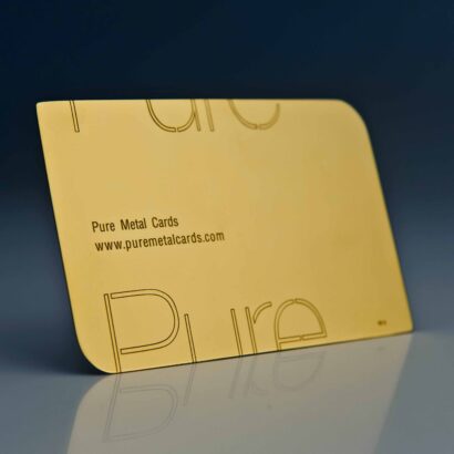 Close-up of a Pure Metal Cards 24 karat gold card with rounded edges. Text: Pure Metal Cards, www.puremetalcards.com