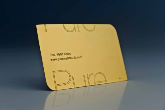 Close-up of a Pure Metal Cards 24 karat gold card with rounded edges. Text: Pure Metal Cards, www.puremetalcards.com
