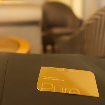 Pure Metal Cards 18kt gold business card on a desk in a hotel
