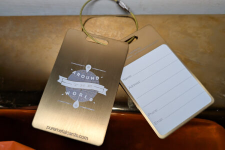 Pure Metal Cards brushed gold titanium metal luggage tags - around the world with gold wire strap