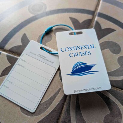 Metal luggage tags for Continental Cruises, featuring a cruise ship logo and contact information form.