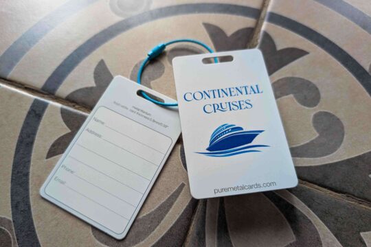 Metal luggage tags for Continental Cruises, featuring a cruise ship logo and contact information form.