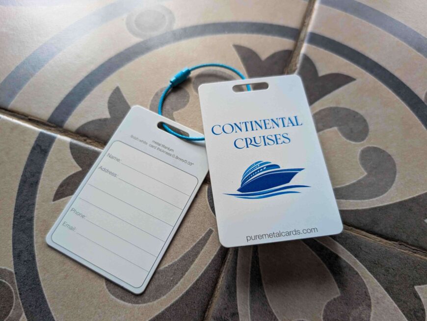 Metal luggage tags for Continental Cruises, featuring a cruise ship logo and contact information form.